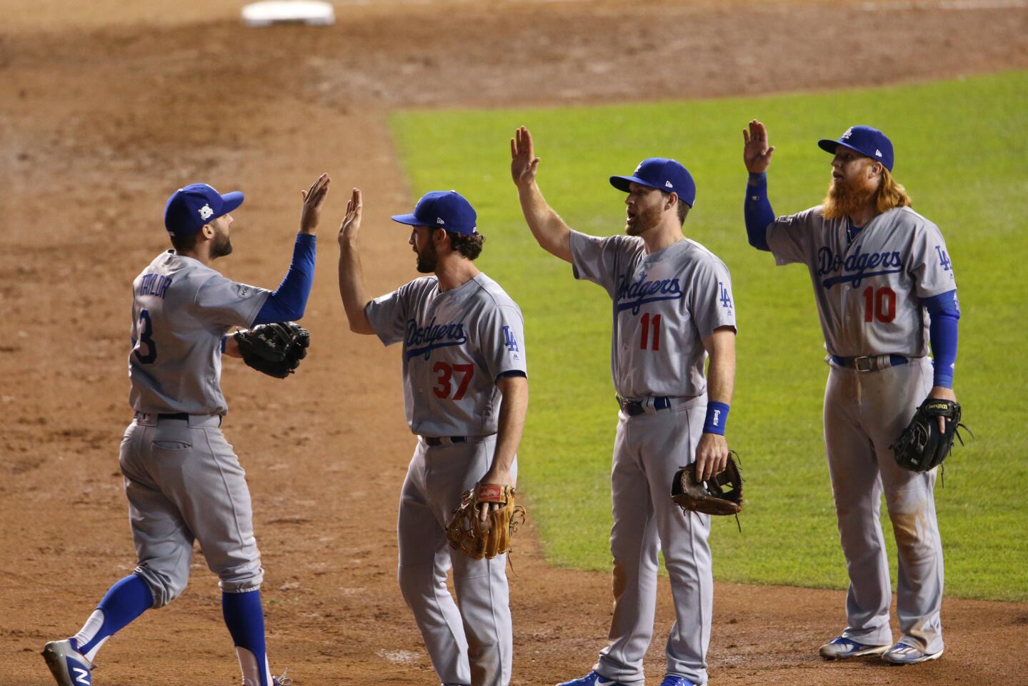 Dodgers players celebrate a 6-1 win over the Cubs.
