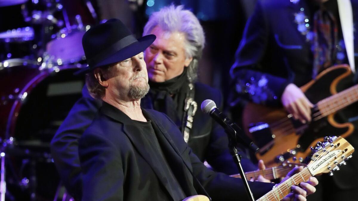 Roger McGuinn, left, of the Byrds, and Marty Stuart perform at the Ryman Auditorium on June 7 in Nashville, Tenn. McGuinn and Byrds co-founder Chris Hillman will tour with Stuart's backing this summer.