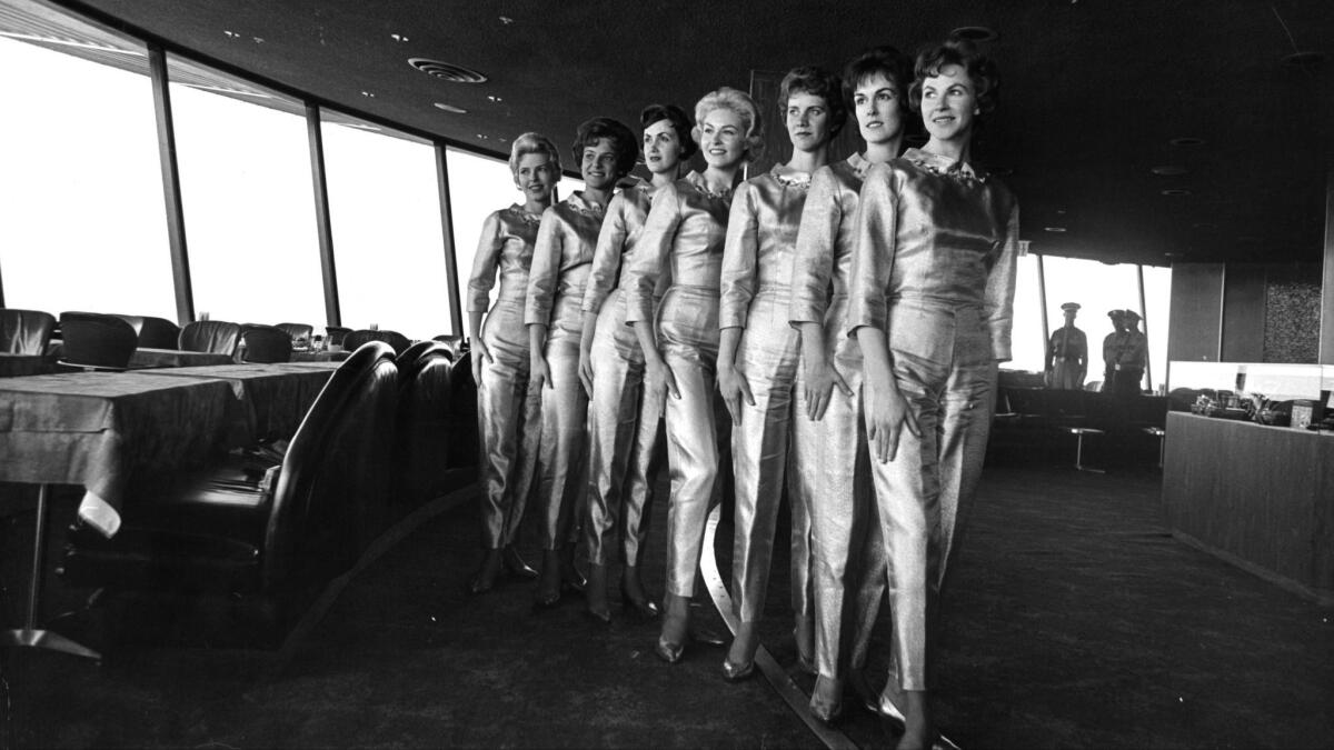 Gold-lamé-suited waitresses inside the Space Needle's restaurant at the Seattle World's Fair.