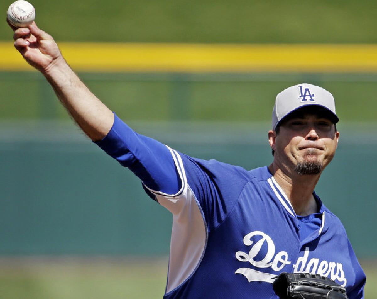 Dodgers pitcher Josh Beckett warms up before an exhibition game against the Chicago Cubs in March.