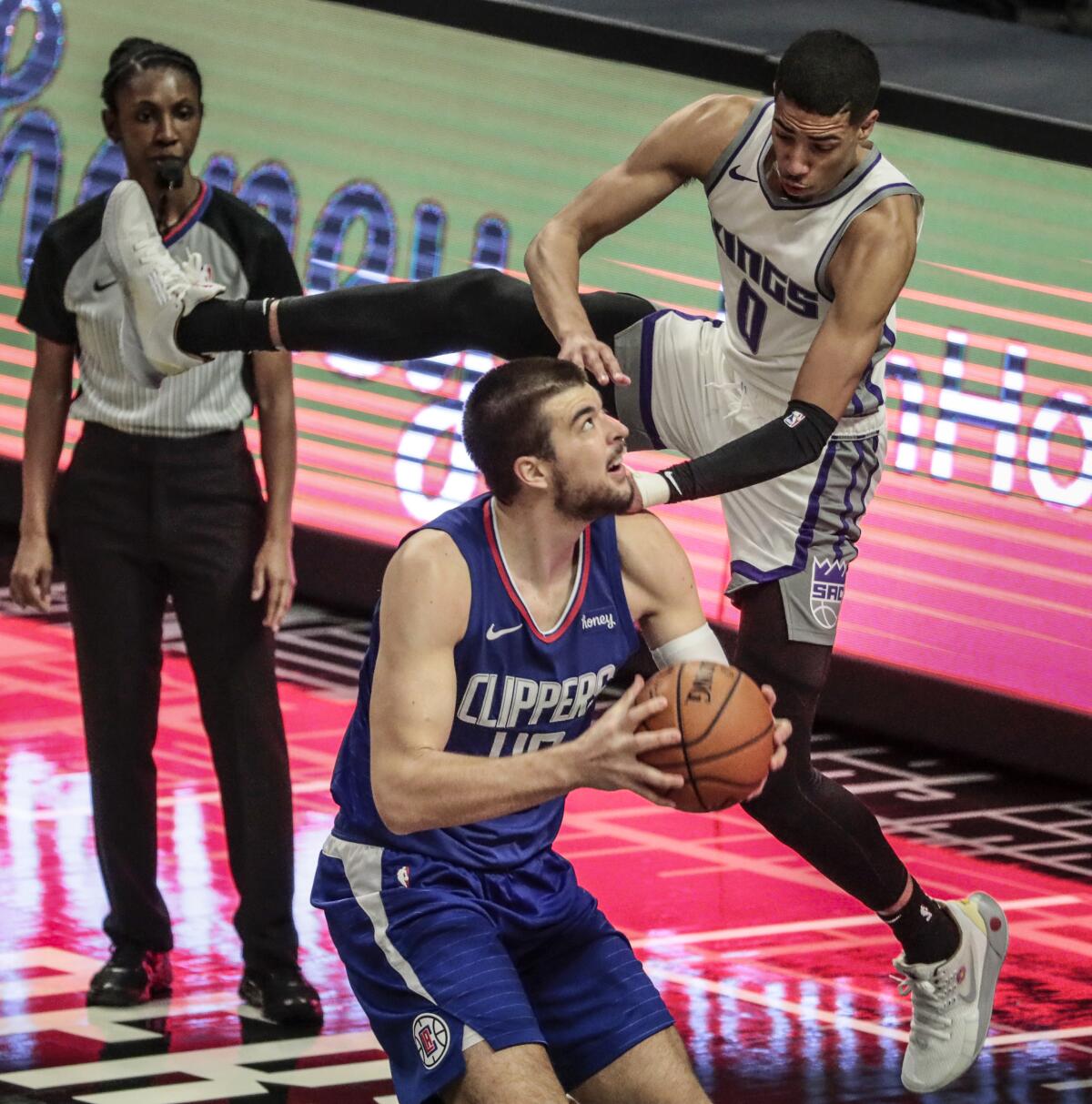 Clippers center Ivica Zubac is fouled by Sacramento Kings guard Tyrese Haliburton on Wednesday at Staples Center.