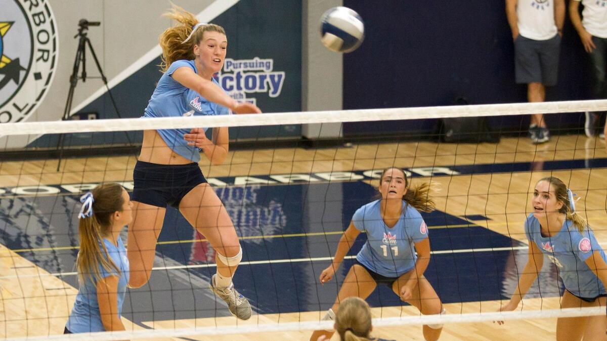 Corona del Mar junior opposite Kendall Kipp hammers a shot at rival Newport Harbor in the Battle of the Bay on Sept. 14, 2017.
