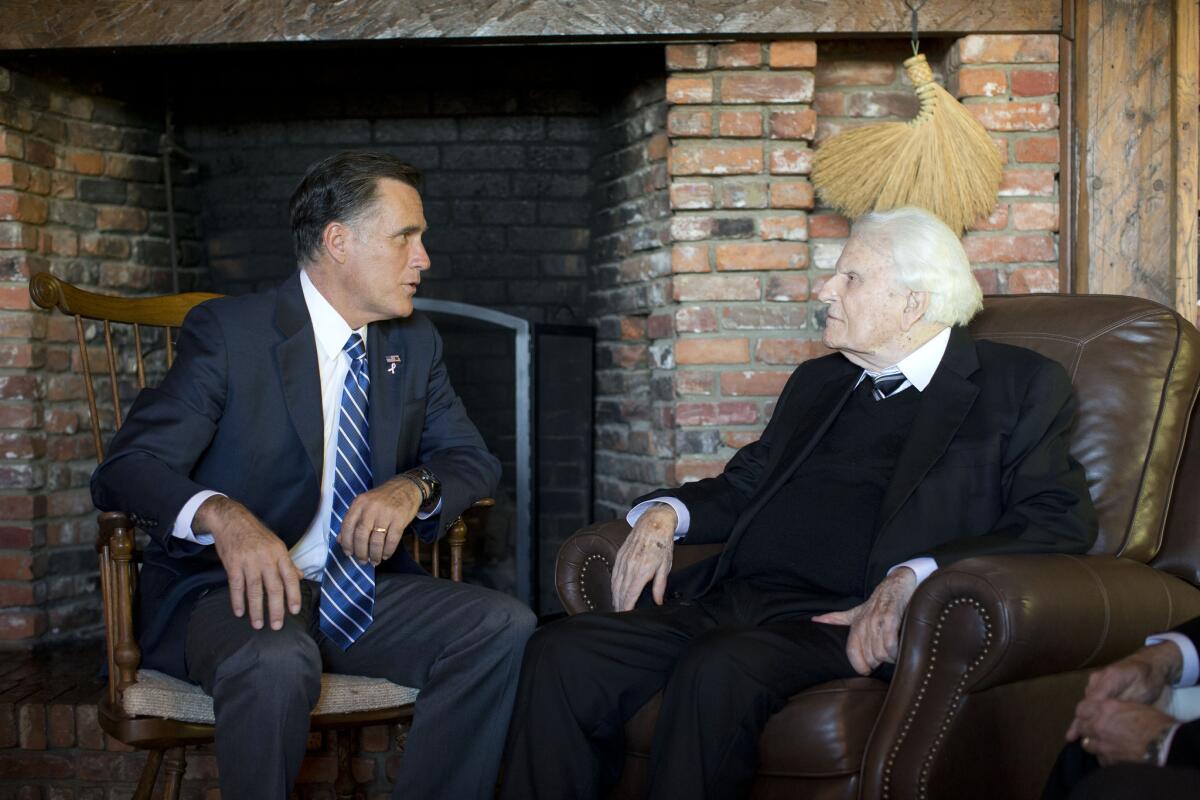 Republican presidential candidate Mitt Romney meets with Rev. Billy Graham, in Montreat, N.C. The Billy Graham Evangelistic Assn. has now removed Mormonism from its list of religious cults.