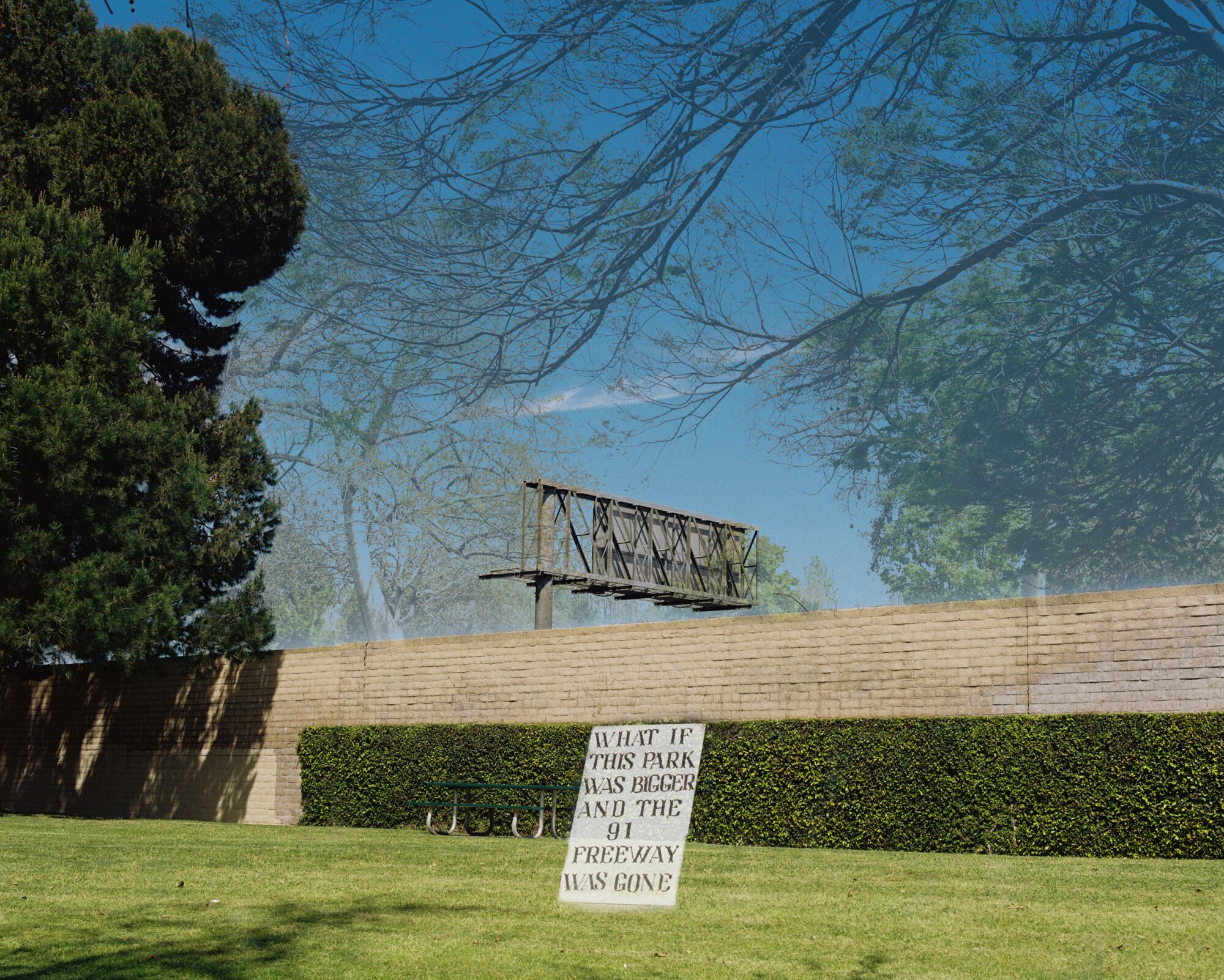 An image of a park overtaking the freeway and a sign reading: "What if this park was bigger and the 91 freeway was gone."
