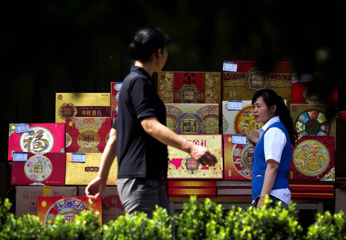 A counter displays fancy boxes of mooncakes, a popular holiday gift, outside a shopping mall in Beijing. Last month, the Chinese government banned the use of public funds to buy mooncakes.