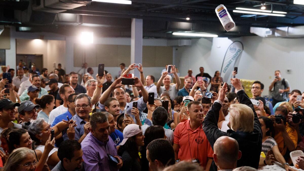 President Trump tosses paper towels into a crowd at Calvary Chapel in Guaynabo, Puerto Rico, on Oct. 3.