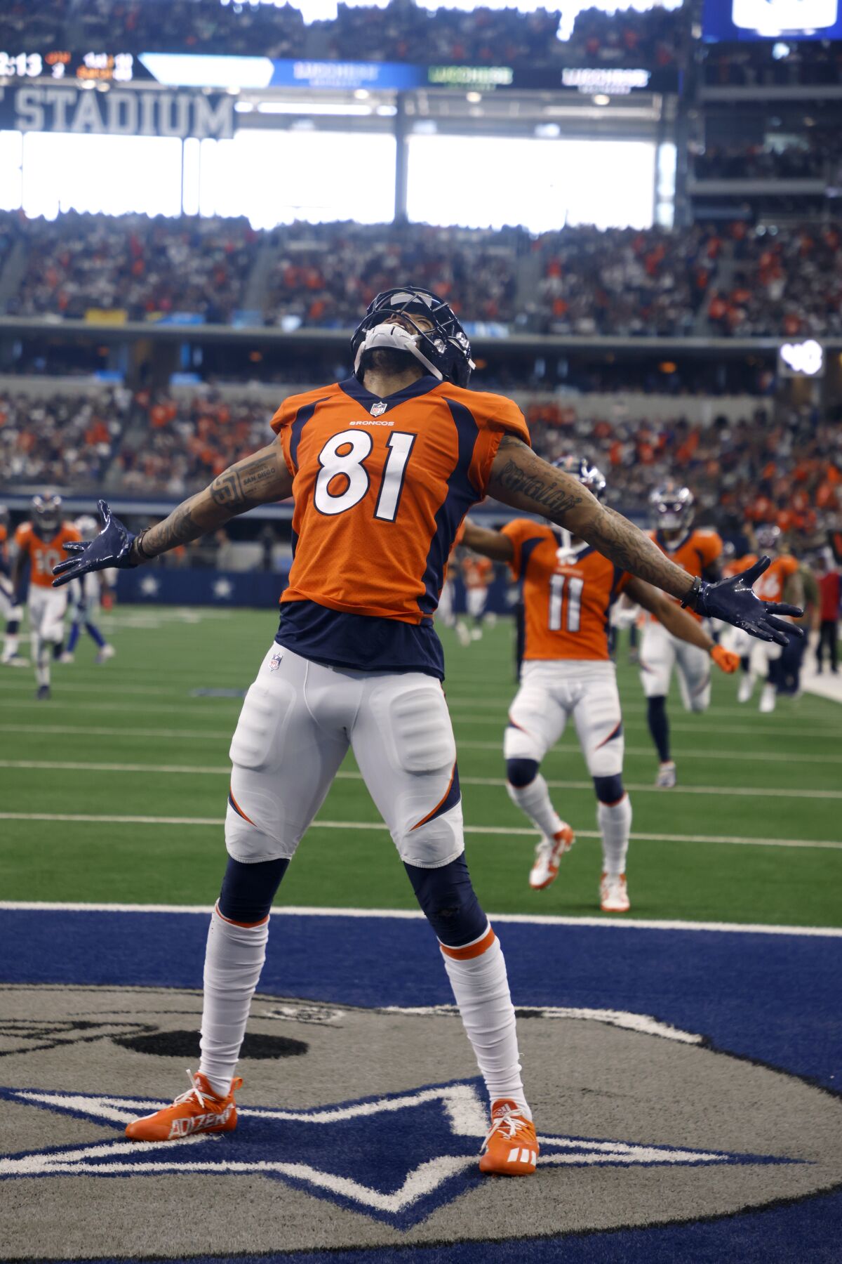 Denver Broncos wide receiver Tim Patrick (81) celebrates catching a touchdown pass in the first half of an NFL football game against the Dallas Cowboys in Arlington, Texas, Sunday, Nov. 7, 2021. (AP Photo/Michael Ainsworth)