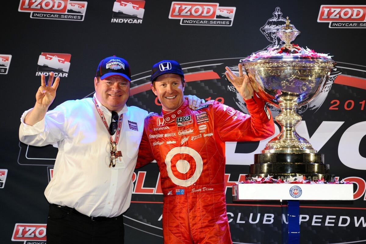 IndyCar Series champion Scott Dixon, right, celebrates his season title with team owner Chip Ganassi after finishing fifth at Saturday night's IndyCar Series race in Fontana.
