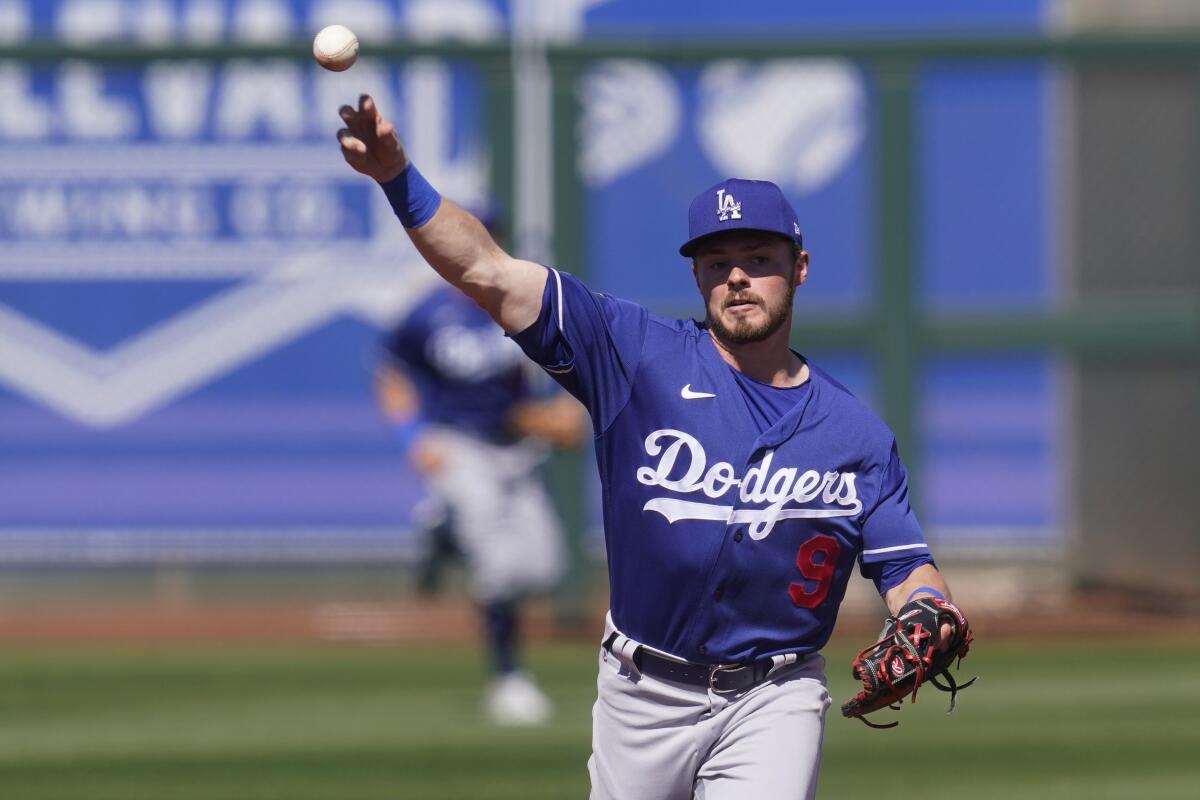 Dodgers second baseman Gavin Lux throws during a spring training game against the Kansas City Royals on Friday.