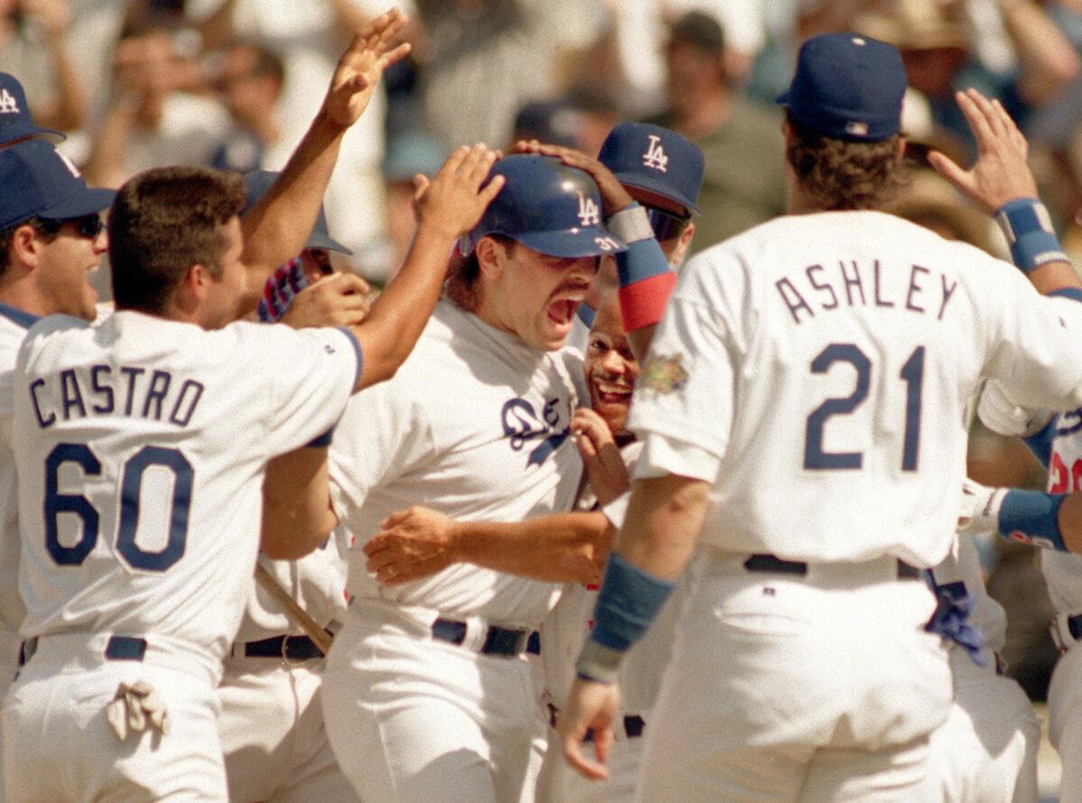Mike Piazza is swarmed by his Dodgers teammates after hitting a game-winning homerun against Houston in 1996.