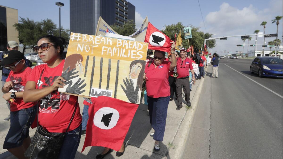 Demonstrators denouncing Trump administration immigration policies protest outside the federal courthouse in McAllen, Texas, on Thursday.