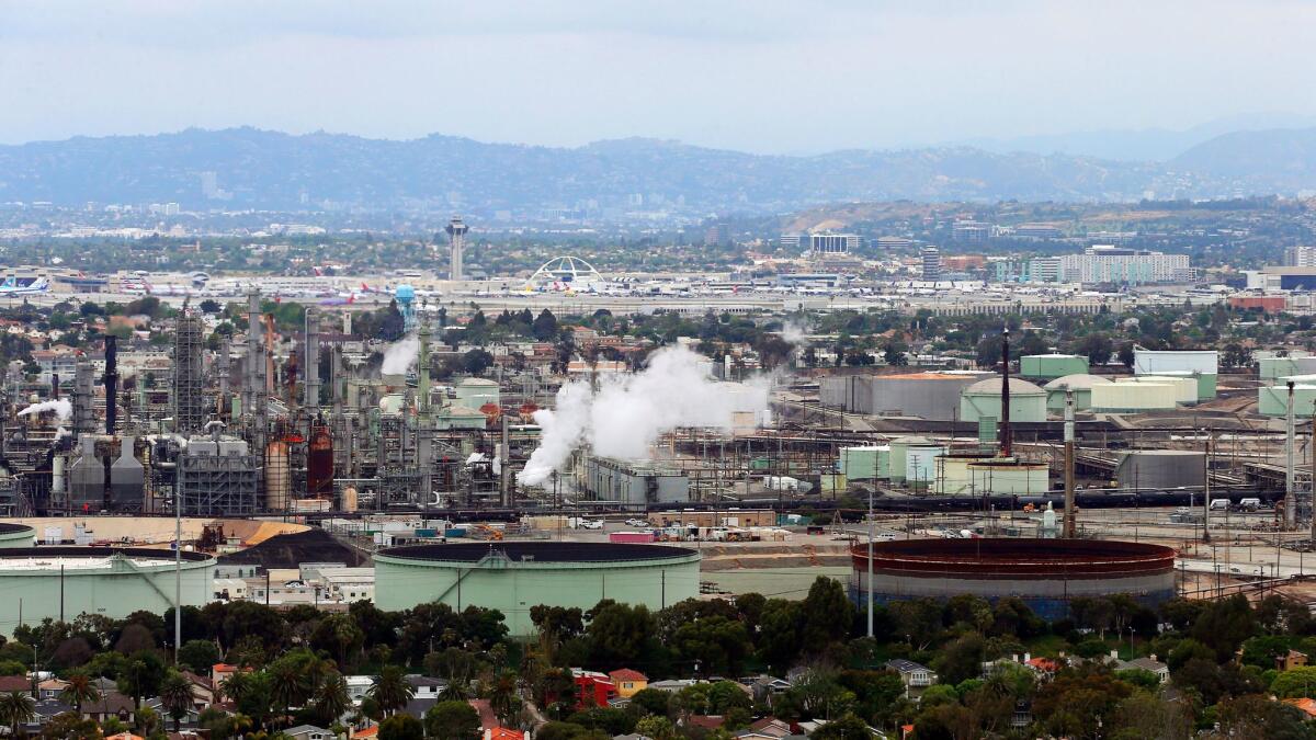 An oil refinery in El Segundo, one of many facilities that must comply with California's cap-and-trade program. (Reed Saxon / Associated Press)