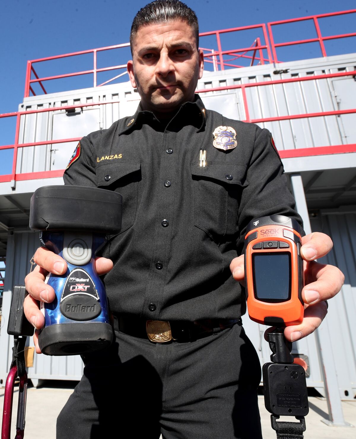 Glendale Fire Chief Silvio Lanzas holds one of the old thermal imaging cameras, left, that the department has been using compared to a newer one, right, that they will equip to all 50 on-duty firefighters beginning Thursday, Jan. 30.