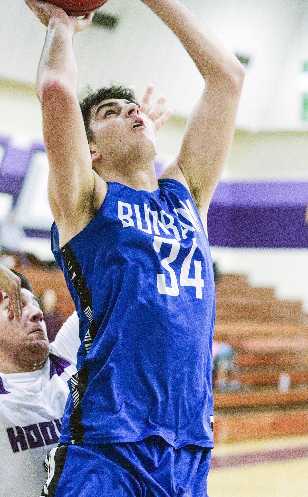 Burbank's Kevin Sarkes gets inside to shoot against Hoover in a Pacific League boys' basketball game at Hoover High School on Friday, January 3, 2020.