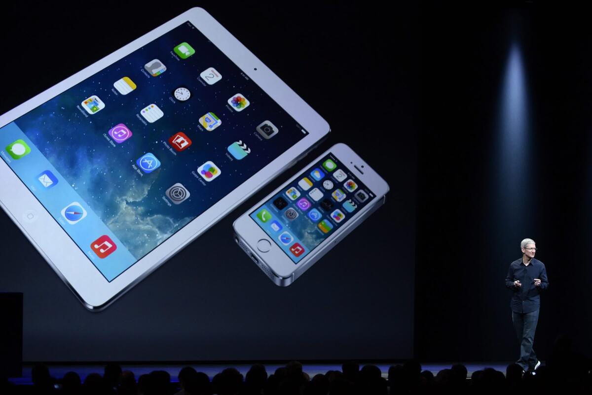 Apple Chief Executive Tim Cook introduces the iOS 8 mobile operating system during his keynote address at the Apple Worldwide Developers Conference on June 2.