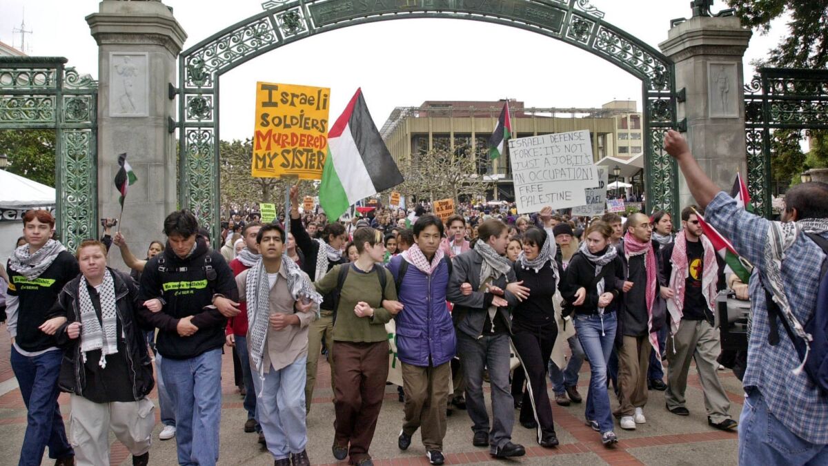 Pro-Palestinian demonstrators march through Sather Gate on the University of California, Berkeley campus.