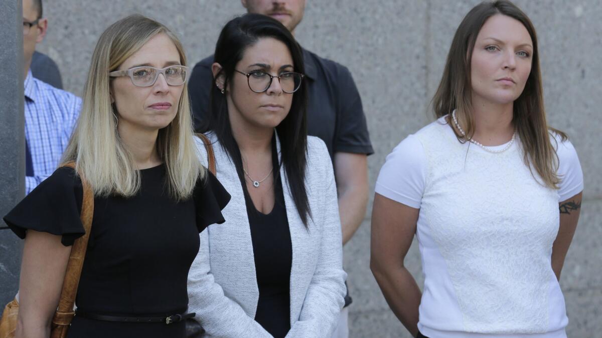 Annie Farmer, left, and Courtney Wild, right, accusers of Jeffrey Epstein, stand outside the courthouse in New York on Monday.