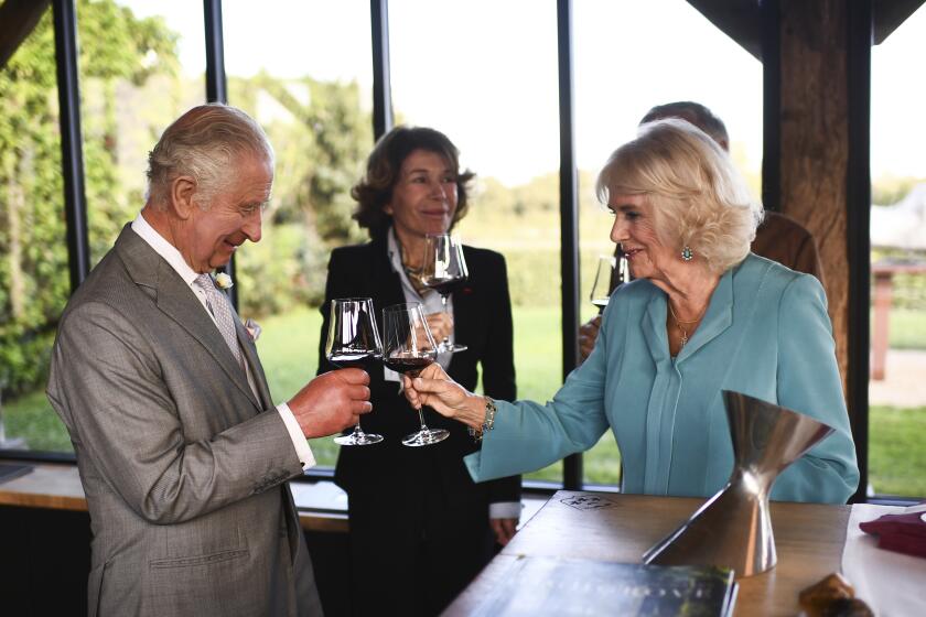 Britain's King Charles III toast with Queen Camilla during a visit to the sustainable vineyard Chateau Smith Haut Lafitte in Martillac, southwestern France, near Bordeaux, Friday Sept.22, 2023. (Christophe Archambault, Pool via AP)