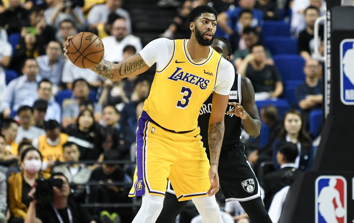 Lakers forward Anthony Davis receives a pass while playing against the Nets in Shanghai on Oct. 10, 2019.