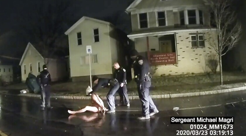 Police body camera video of a Rochester police officer putting a hood over Daniel Prude's head as he sits naked in the street