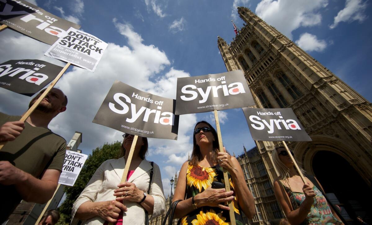 Demonstrators protest against any British military involvement in Syria outside the Houses of Parliament in London on Thursday.