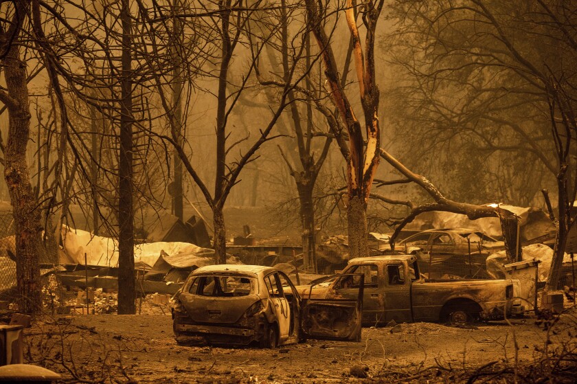 Scorched vehicles and residences in the Klamath River as the McKinney Fire burns in Klamath National Forest, Calif.