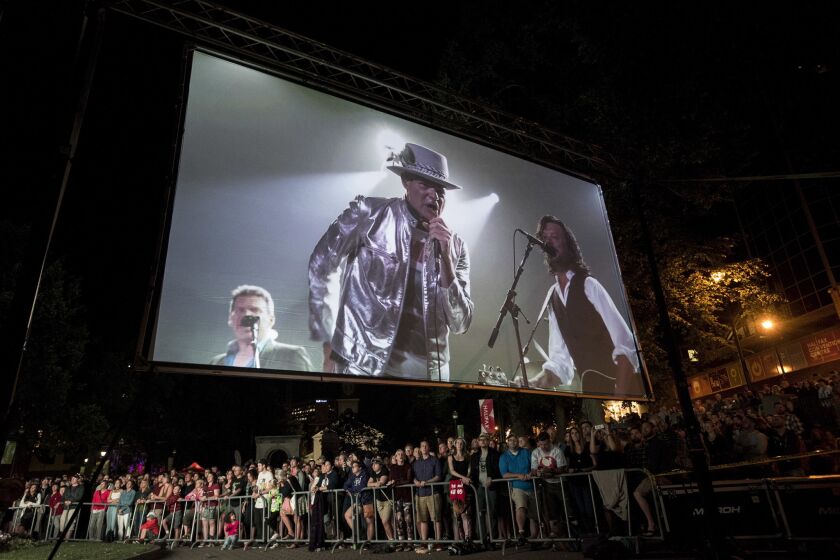 Gord Downie of the Tragically Hip onstage in Toronto and projected at a viewing party in Halifax, Canada.