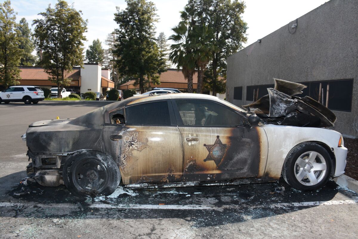 An exterior image of a burned police car.