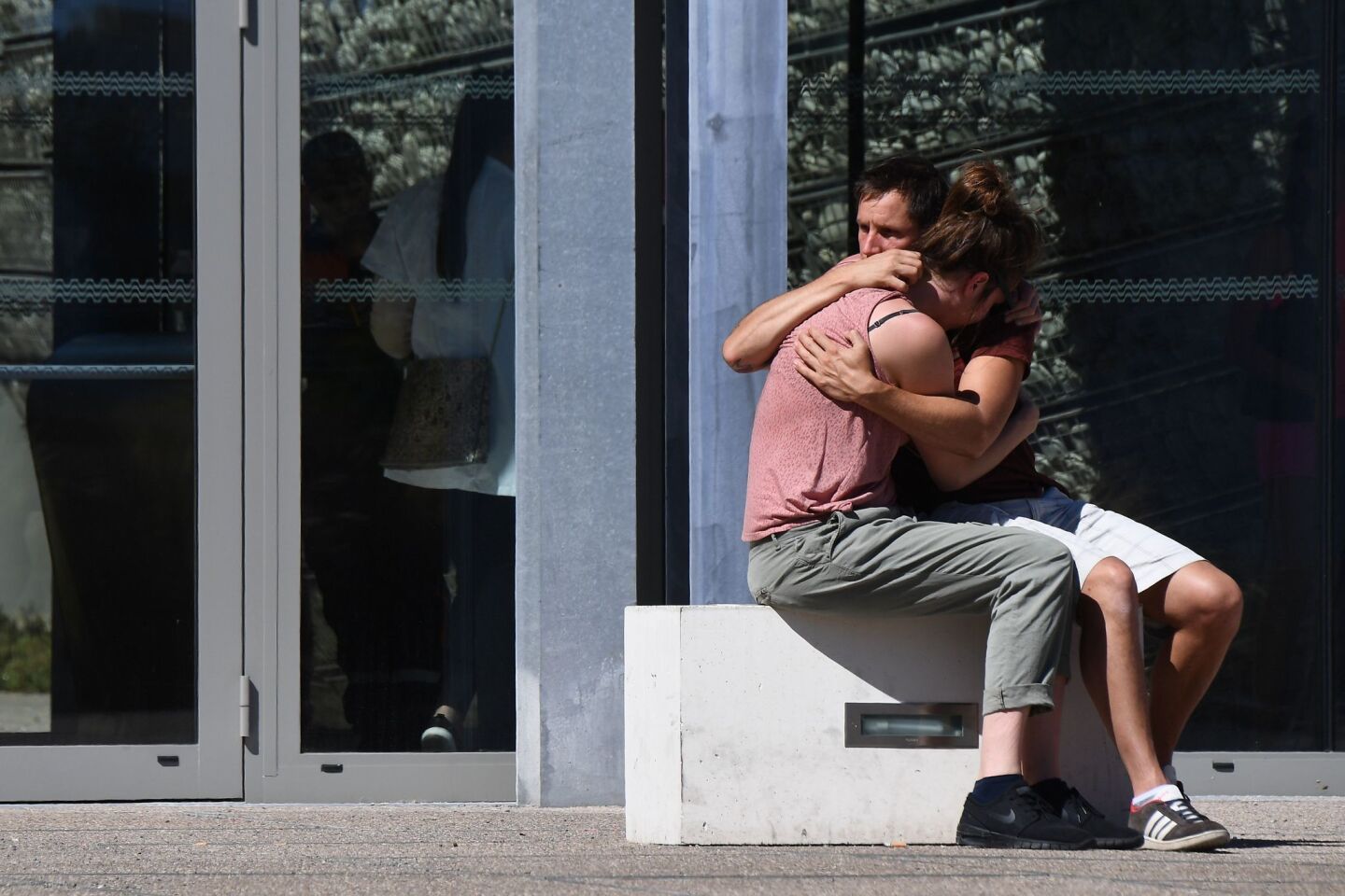 People hug outside Pasteur Hospital in Nice after the July 14 truck attack that killed 84 people.