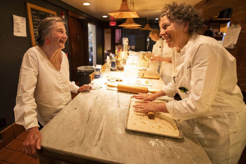BERKELEY, CA-JUNE 14, 2019: Retired pastry chef LIndsey Shere, left, talks with pastry chef Mary Jo Thorensen as she prepares a nougat montelimar, while working inside the kitchen at Chez Panisse in Berkeley. (Mel Melcon/Los Angeles Times)