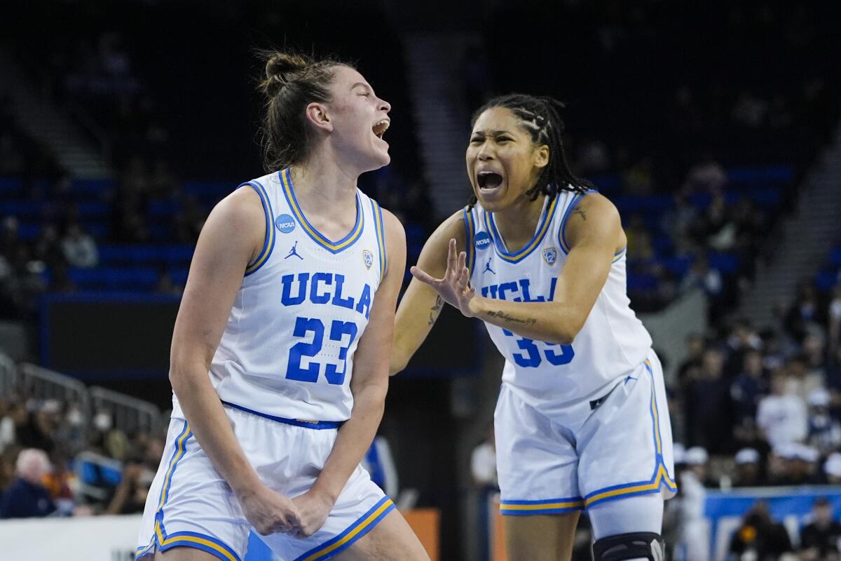 UCLA forward Gabriela Jaquez, left, celebrates with guard Camryn Brown after drawing a foul.