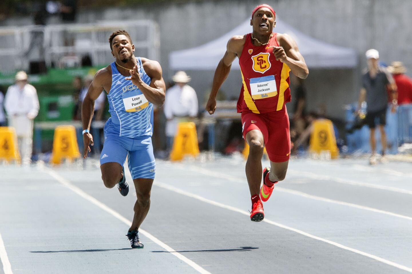 USC sophomore Adoree' Jackson runs past UCLA's Leon Powell in the men's 100m dash during the UCLA vs. USC Track and Field dual meet.