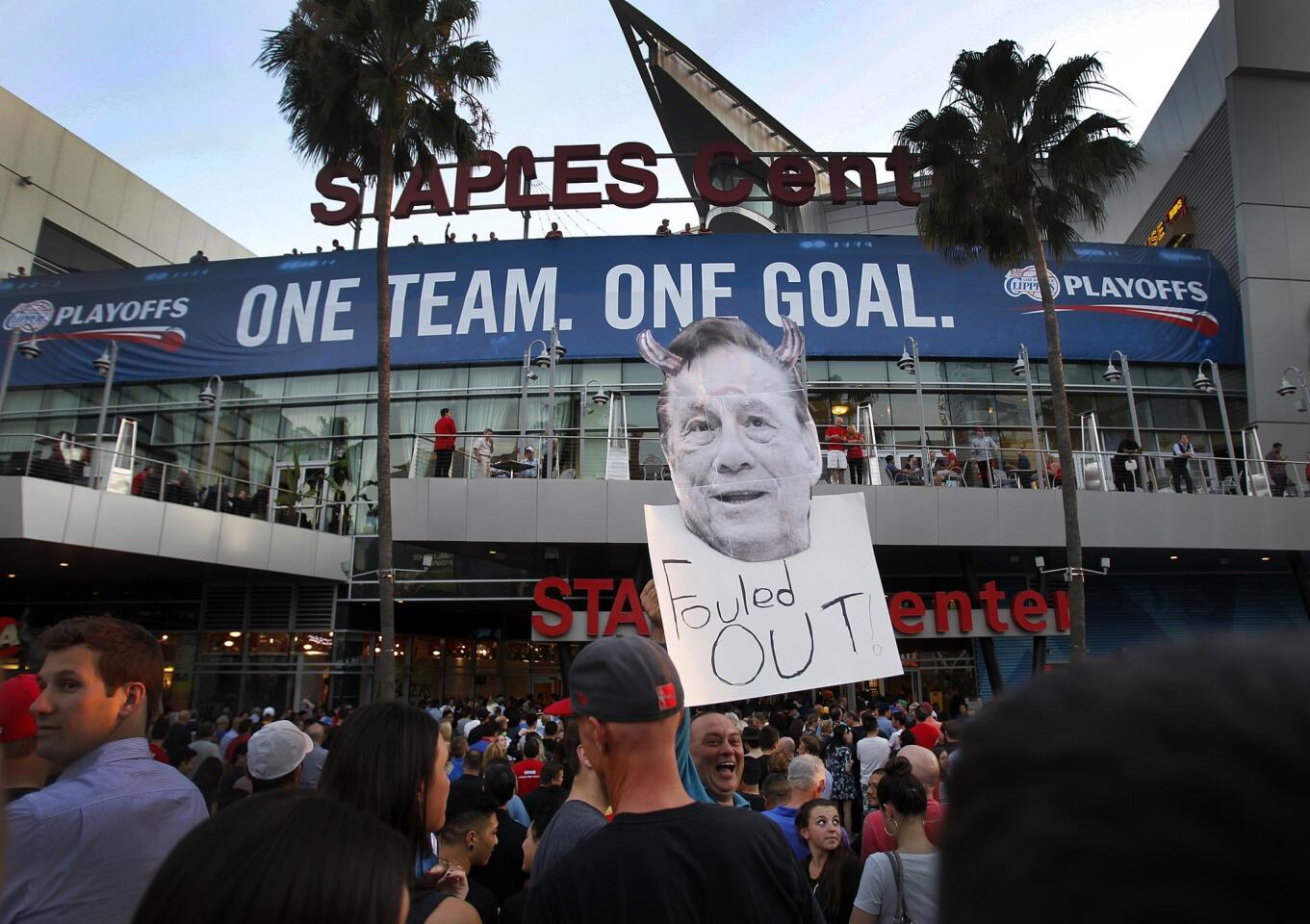 Longtime Clippers fan Abe Dilanian, center, holds up a sign in protest of team owner Donald Sterling outside Staples Center prior to the start of Game 5 of the Western Conference quarterfinals against the Golden State Warriors.