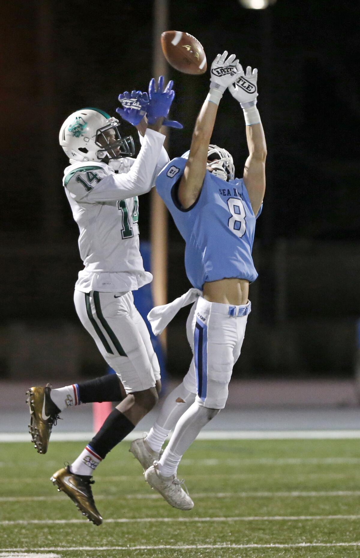 Corona del Mar's Ryder Haupt breaks up a pass intended for Oceanside's Nicholas Williams in the CIF State Southern California Regional Division 1-A Bowl Game on Saturday at Newport Harbor High.