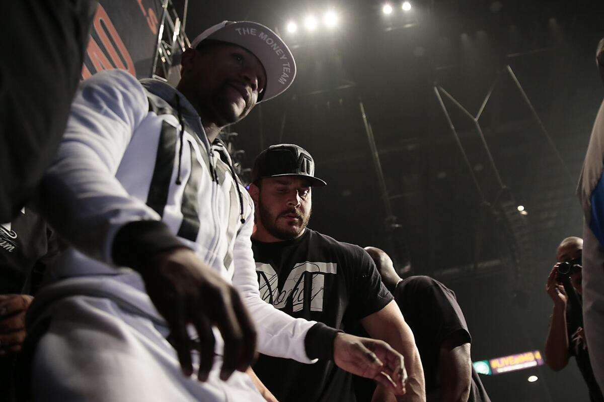 Floyd Mayweather Jr. is directed to the stage during a rally at the MGM Grand Garden Arena in Las Vegas on April 28.