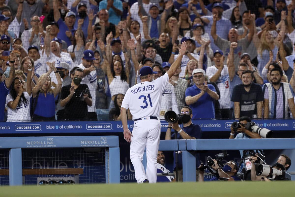 Los Angeles Dodgers starting pitcher Max Scherzer takes a curtain call during the seventh inning of a baseball game against the Houston Astros in Los Angeles, Wednesday, Aug. 4, 2021. Scherzer threw 109 pitches, and struck out ten Astro batters. (AP Photo/Alex Gallardo)