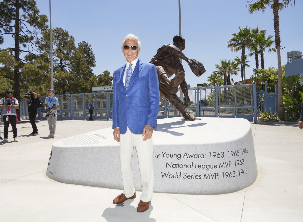 Sandy Koufax stands before a newly unveiled statue of himself at Dodger Stadium.