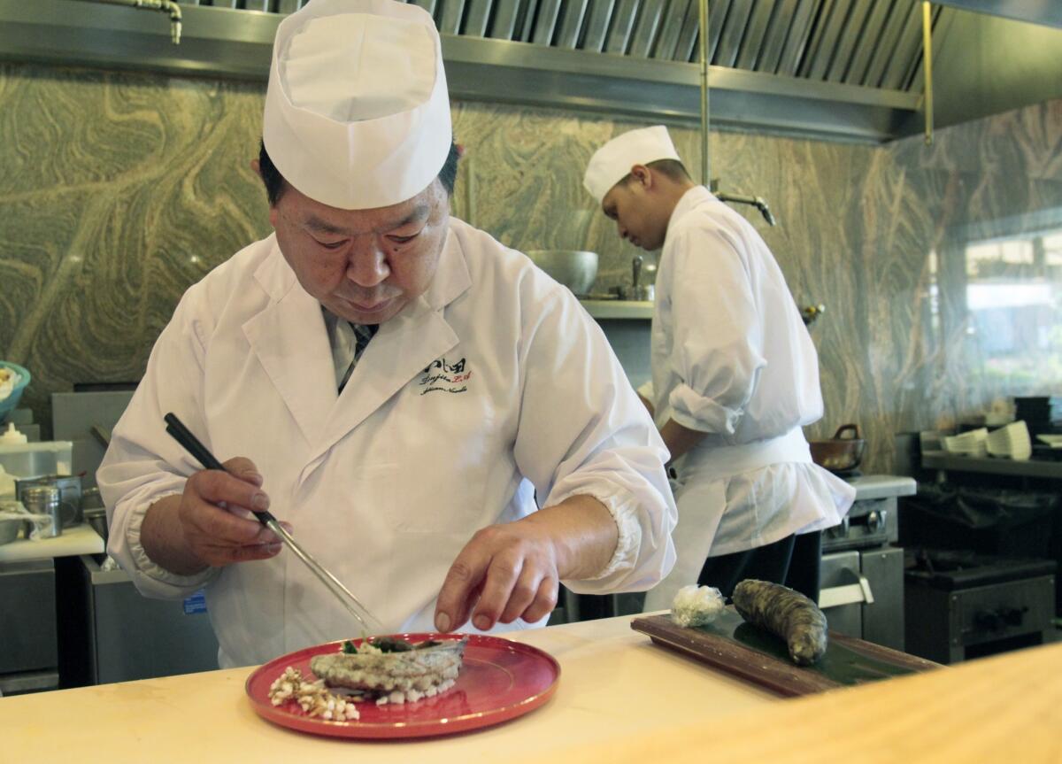 Chef Shigeru Kato, a native of Tokyo, creates one of his edomae-style sushi dishes. His sushi resembles delicate, exquisitely scented Japanese charcuterie.
