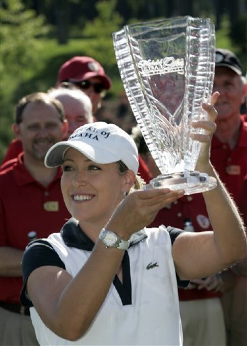 Cristie Kerr holds the winner's trophy after her victory in the LPGA Michelob Ultra Open golf tournament at Kingsmill Golf Club in Williamsburg, Va., Sunday, May 10, 2009. Kerr won the tournament at 16 under par. (AP Photo/Steve Helber)