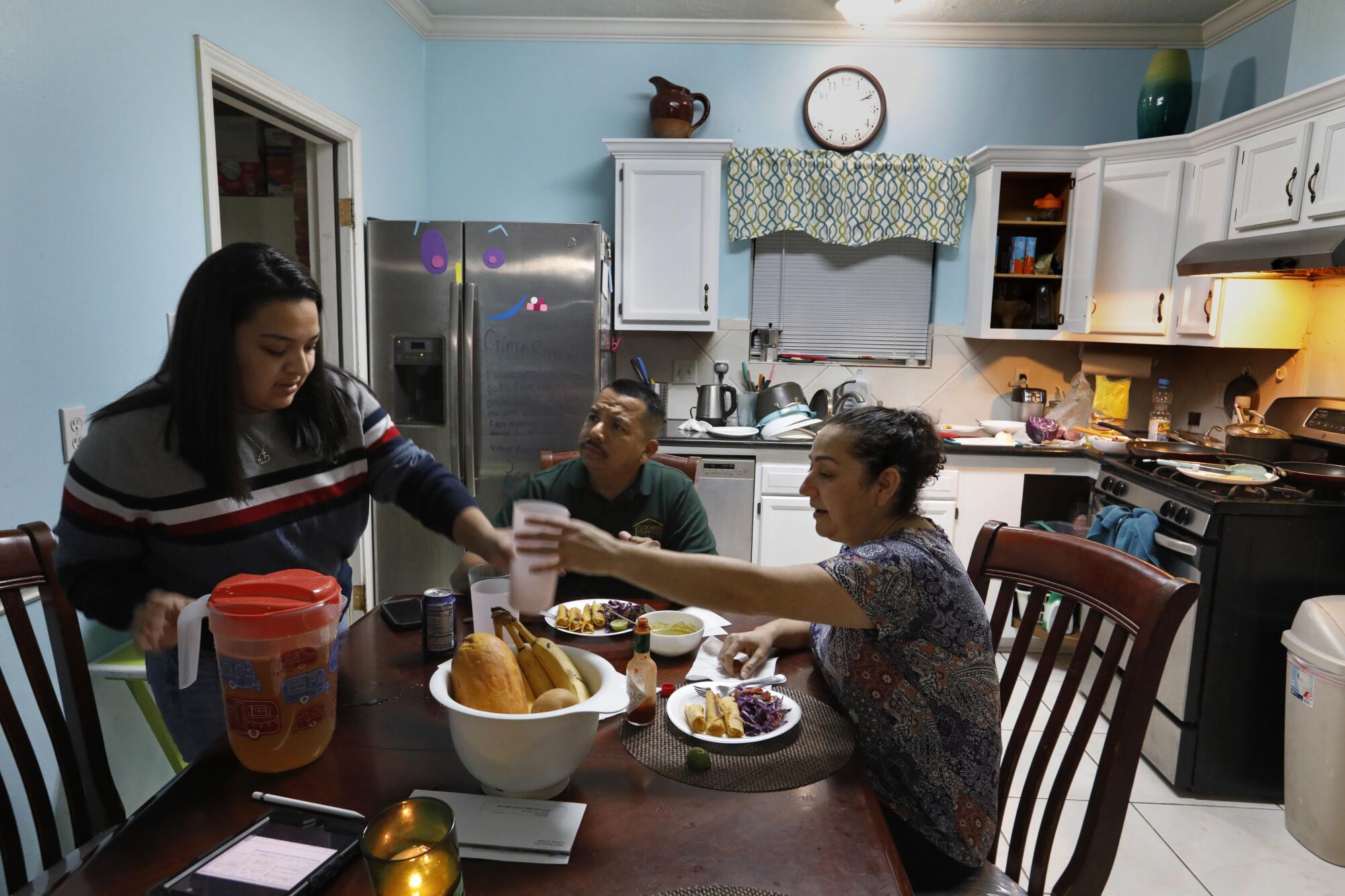 Flor Treviño makes dinner after work for husband Jose  and daughter Stacy, 17.