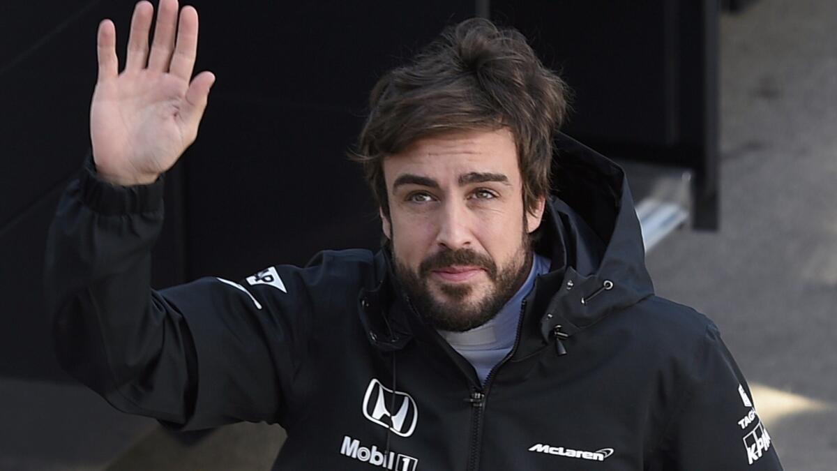 McLaren driver Fernando Alonso waves during a Formula One preseason testing session in Spain on Friday.