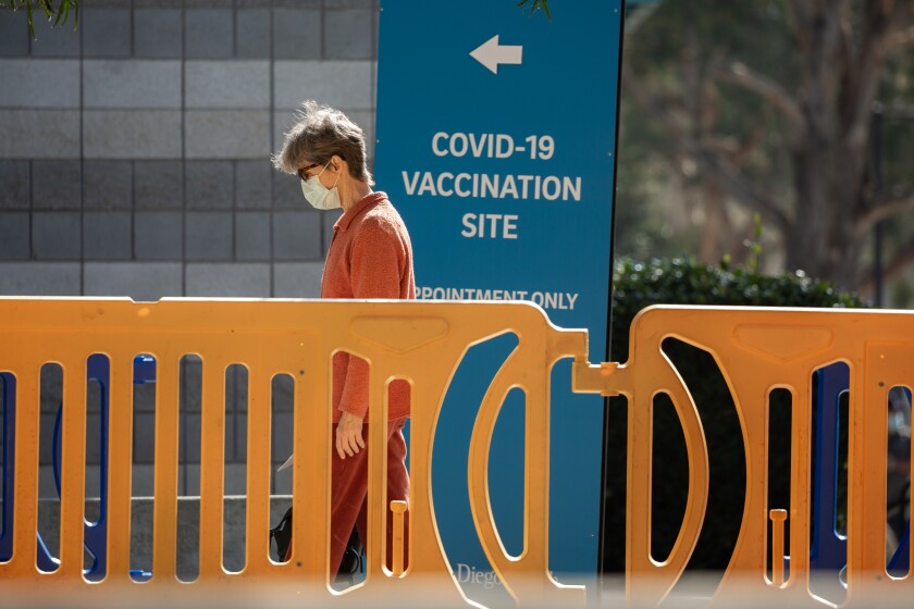A freshly vaccinated person exits the vaccination superstation at UC San Diego's RIMAC arena in February.