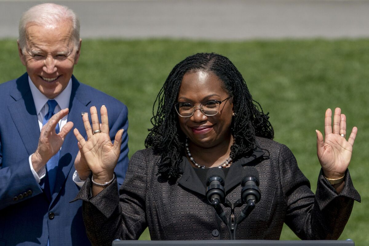 Judge Ketanji Brown Jackson waves as she takes the podium to speak during an event on the South Lawn of the White House