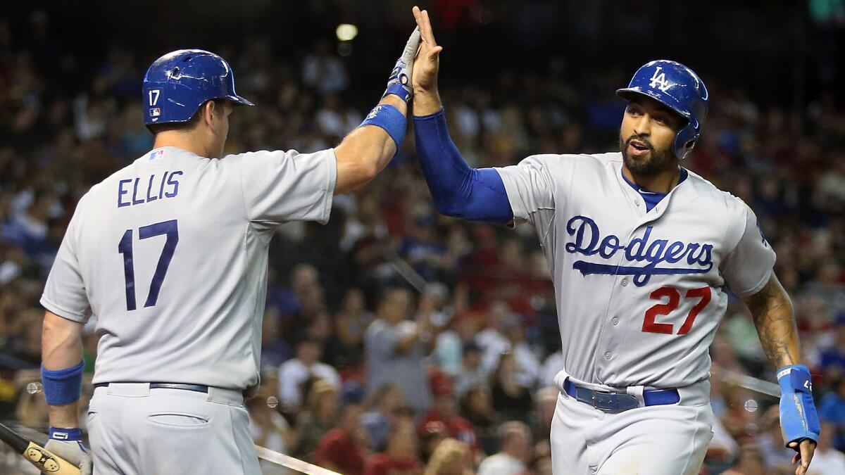 Dodgers outfielder Matt Kemp, right, is congratulated by teammate A.J. Ellis after scoring a run during the fourth inning of Tuesday's win over the Arizona Diamondbacks.