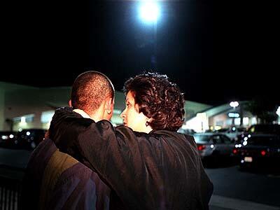 Linda Lopez, right, draps an arm around Jesse, the night he is released from Theo Lacy Men's Jail.