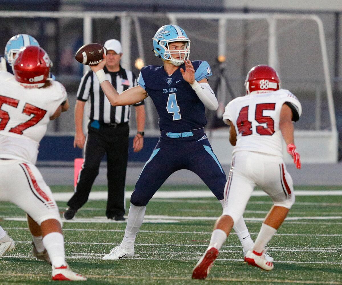 Corona del Mar quarterback Ethan Garbers completes a pass against Lakewood in a nonleague game at Newport Harbor High on Friday.