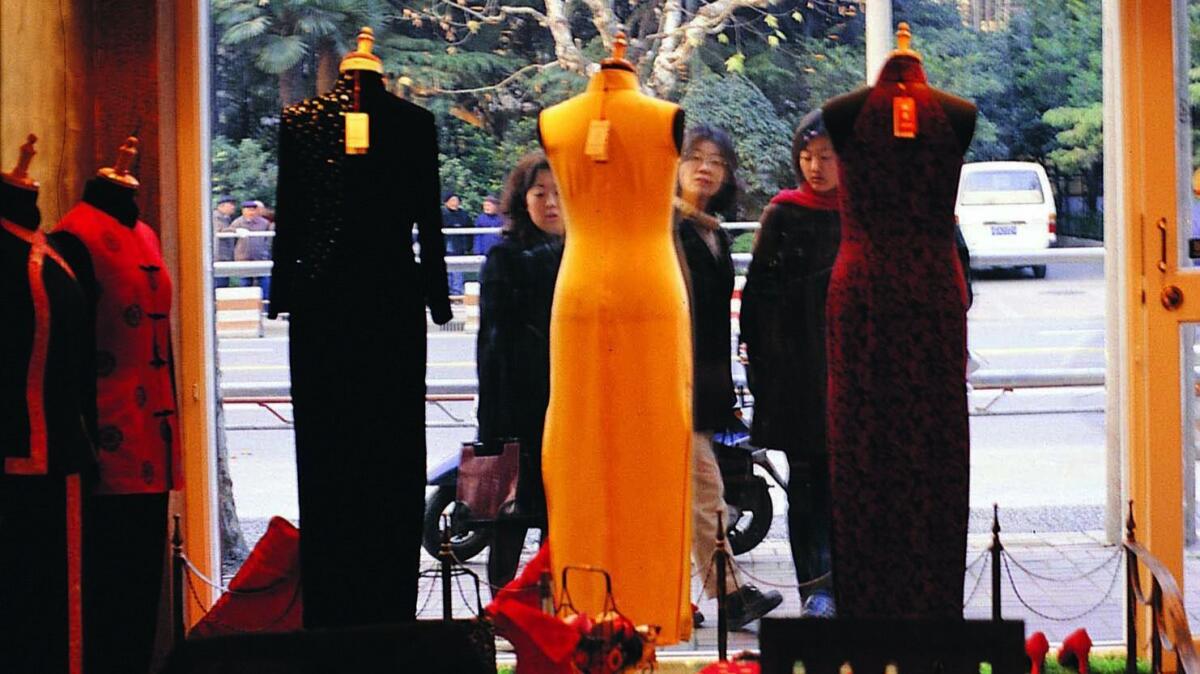 Qipaos, a traditional Chinese dress, in a store window in Shanghai.