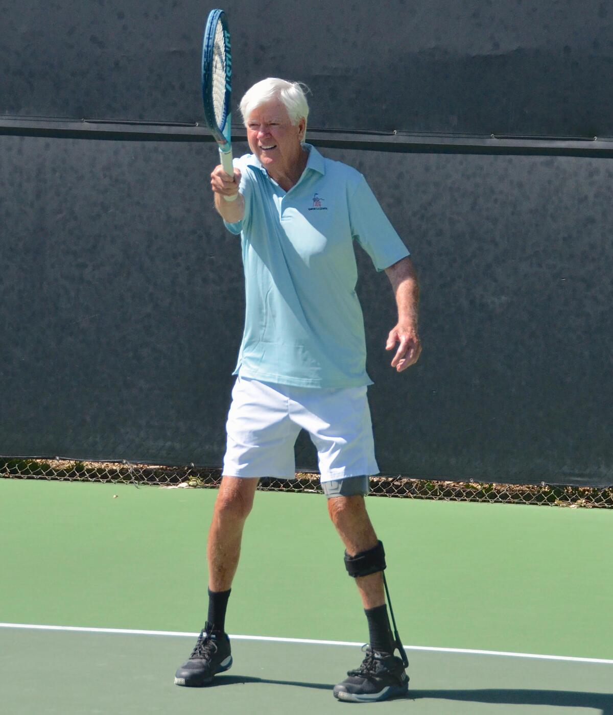 Larry Collins hits a forehand as he plays tennis at the Palisades Tennis Club in Newport Beach on Monday.