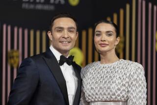 Ed Westwick and Amy Jackson pose together at an awards show