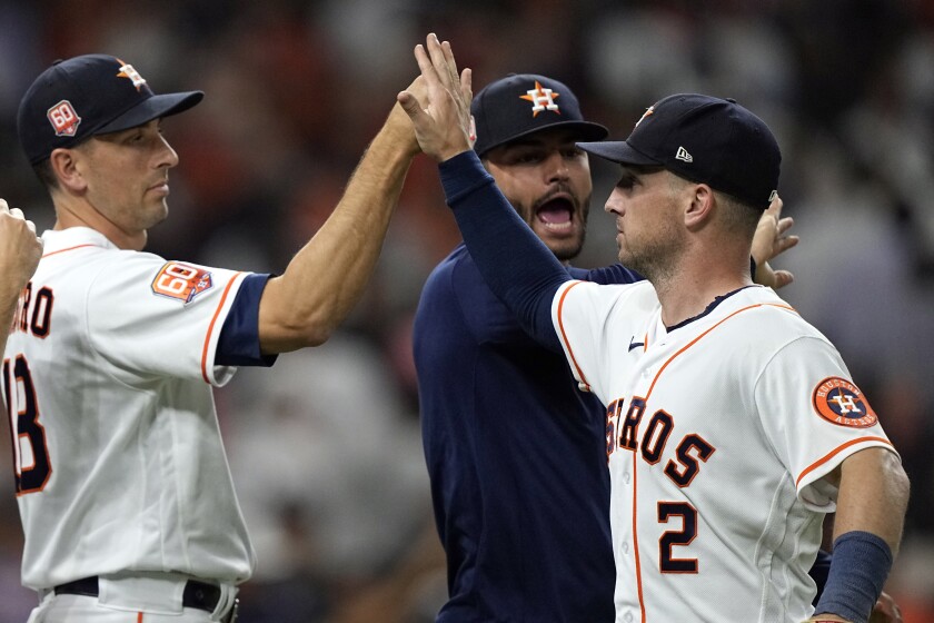 Houston Astros' Alex Bregman (2), celebrates with Jason Castro (18) and Lance McCullers Jr. after a baseball game against the New York Yankees Thursday, June 30, 2022, in Houston. The Astros won 2-1. (AP Photo/David J. Phillip)